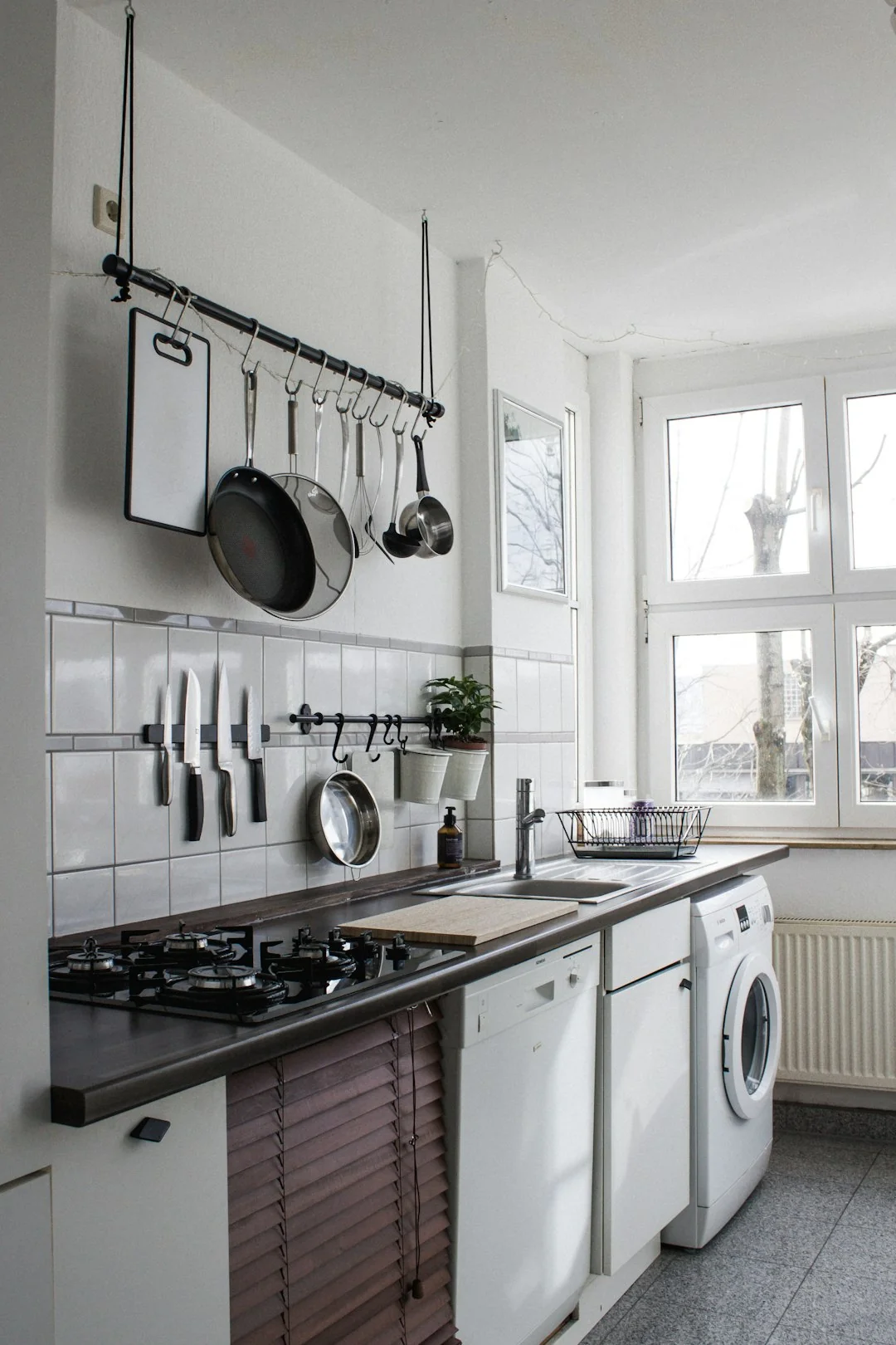 Person using spray bottle and cloth for cleaning a kitchen shelf, ensuring hygiene and cleanliness.